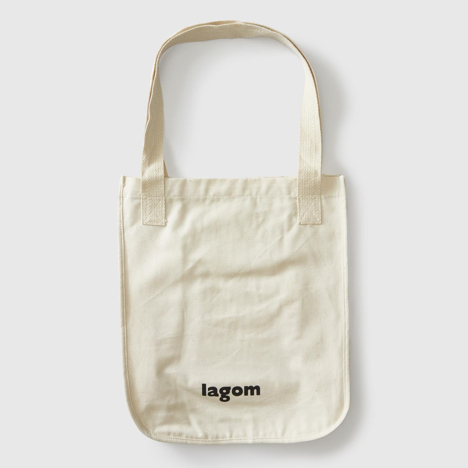 Back of natural Market Tote with black lagom mpls logo near bottom. popular culture, pop culture, minnesota, twin cities, minneapolis, st paul, minnesota-themed clothing, clothing, apparel, accessories, gifts, goods, totes, tote bags, tote