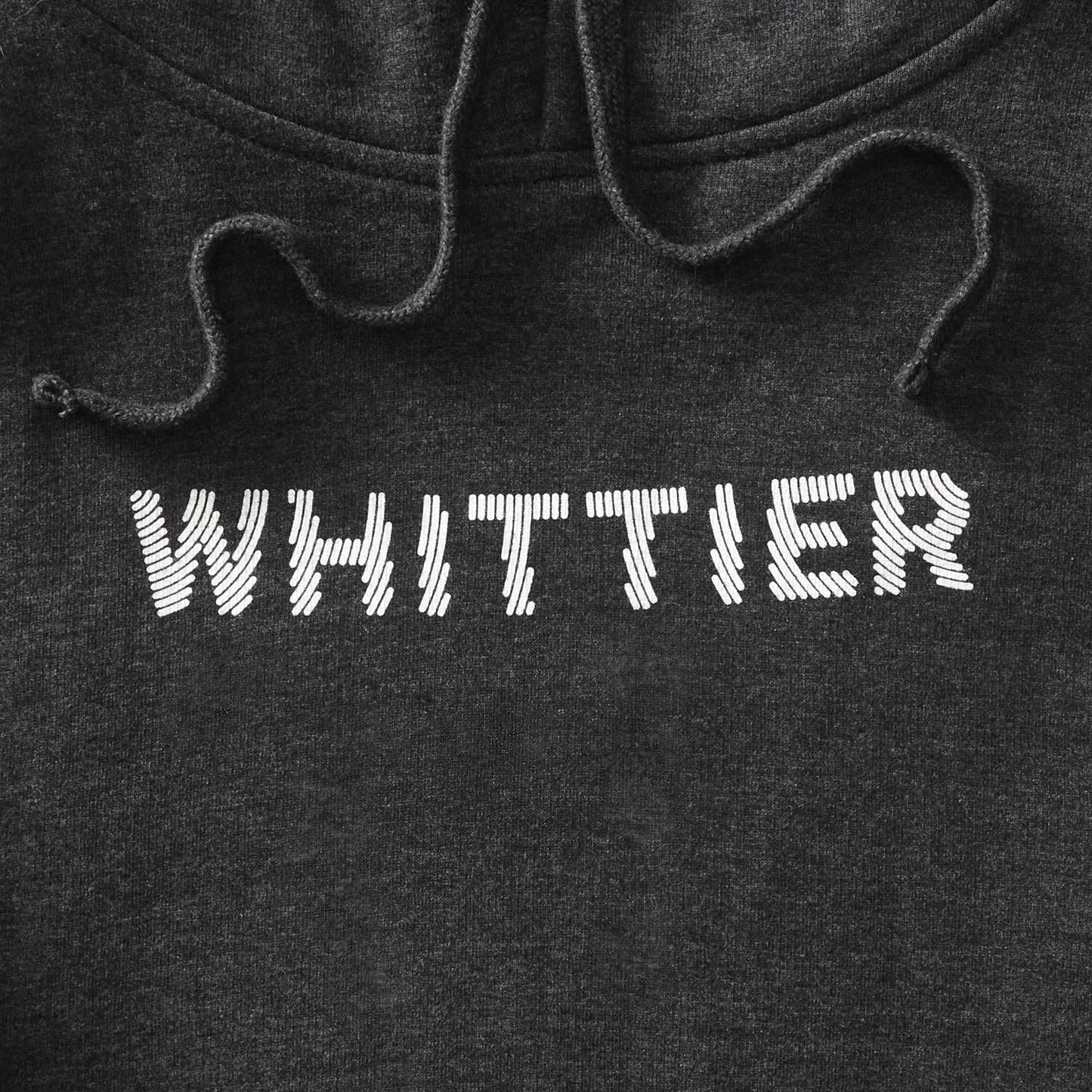 Details of charcoal heather pullover hoodie with Whittier text in white with line effect. minnesota clothing, minnesota apparel, minnesota accessories, minnesota gifts, minnesota goods, minnesota-themed clothing, minnesota-themed apparel, minnesota-themed gifts, minnesota-themed goods, twin cities clothing, twin cities apparel, twin cities accessories, minneapolis clothing, minneapolis apparel, twin cities neighborhoods, minneapolis neighborhoods